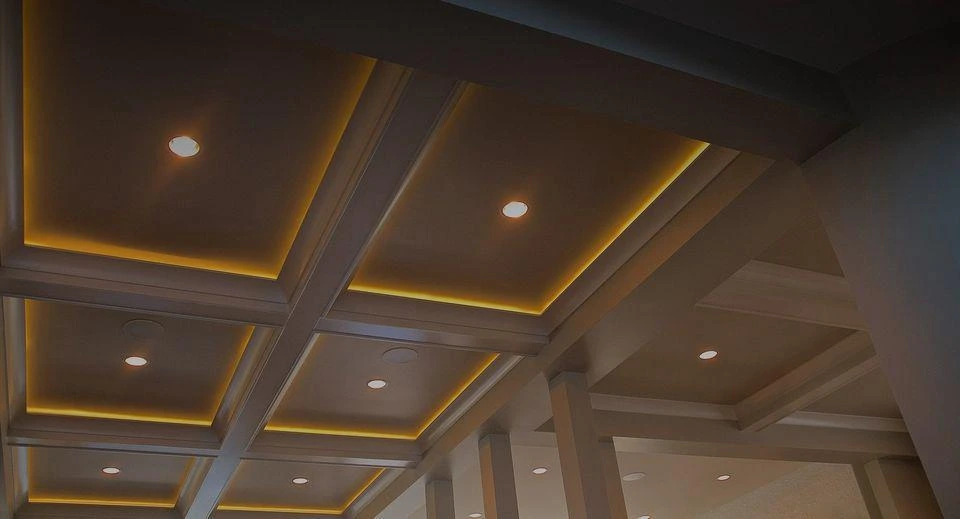 Coffered ceiling with warm LED cove lighting and recessed downlights