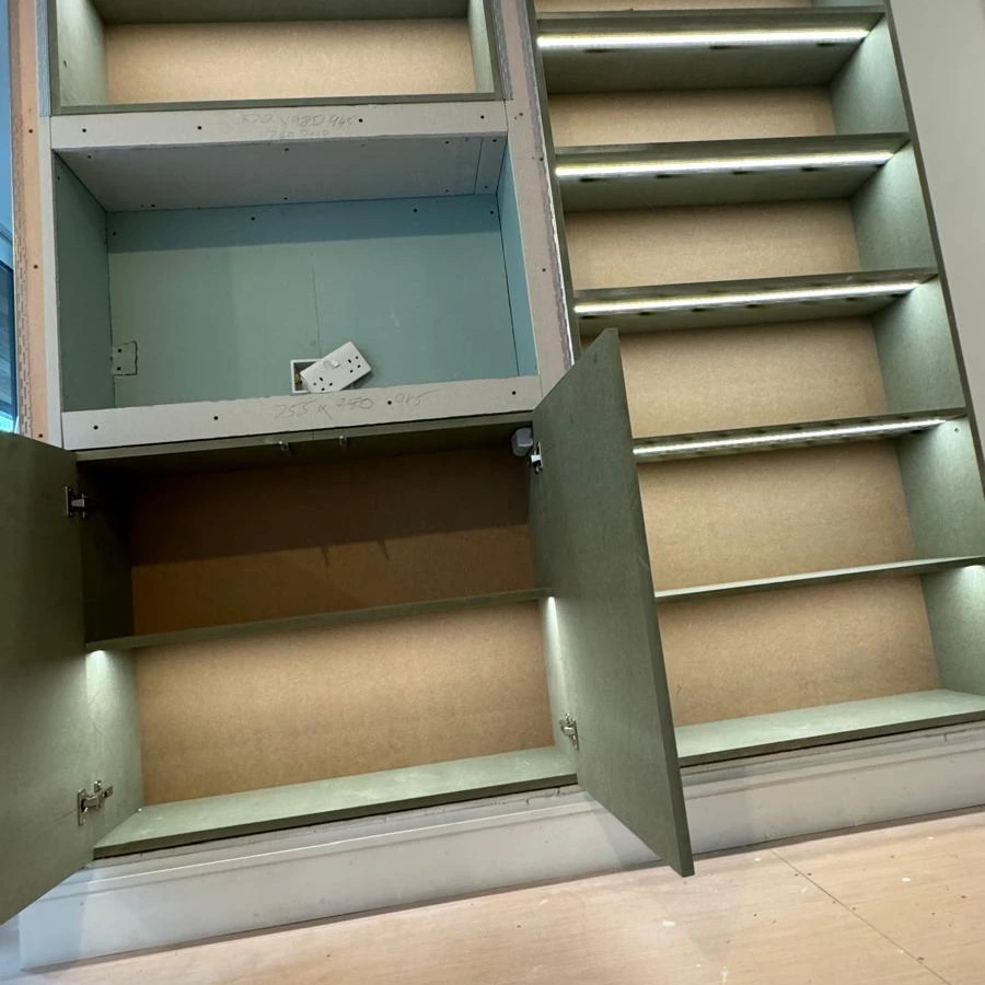Built-in shelving units with LED strip lighting under each shelf