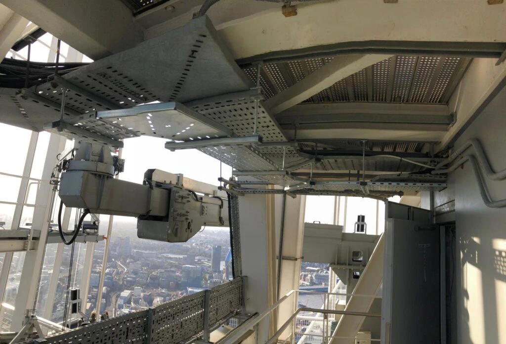 Close up shot of metal machinery on top of a tall structure