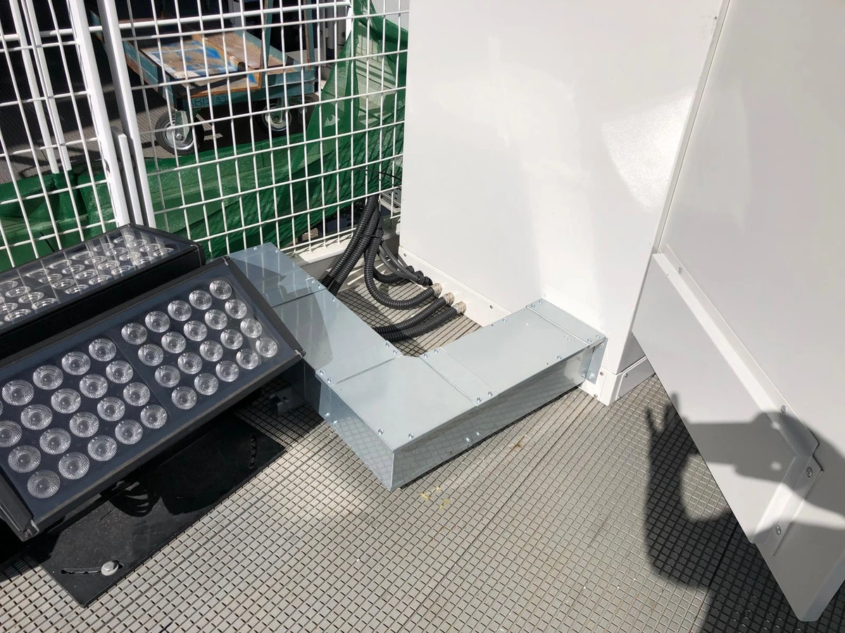 Floodlight fittings and metal trunking installed on a rooftop plant platform