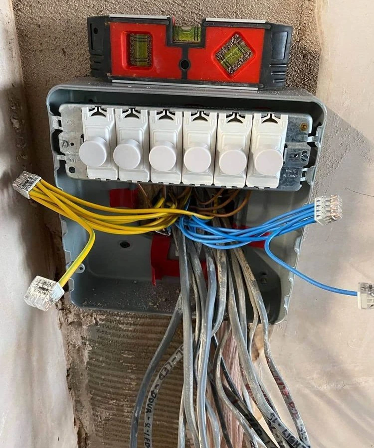 Bank of six dimmer modules wired into a back box with labelled cables