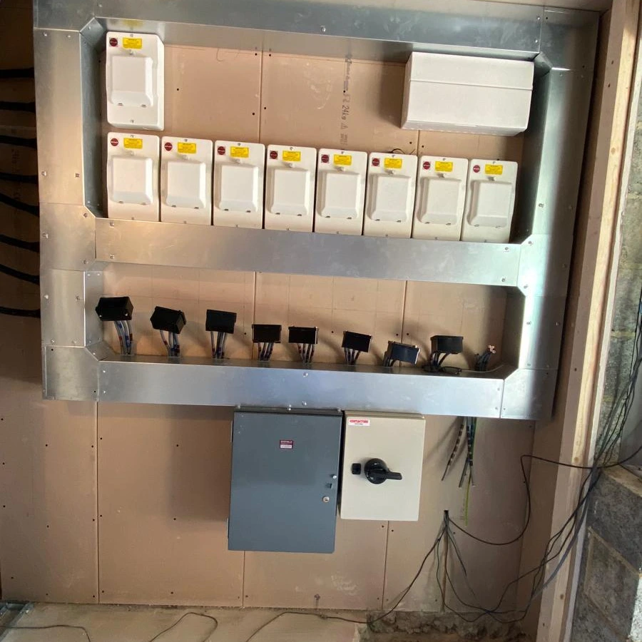 Wall-mounted distribution board with isolator in an unfinished building