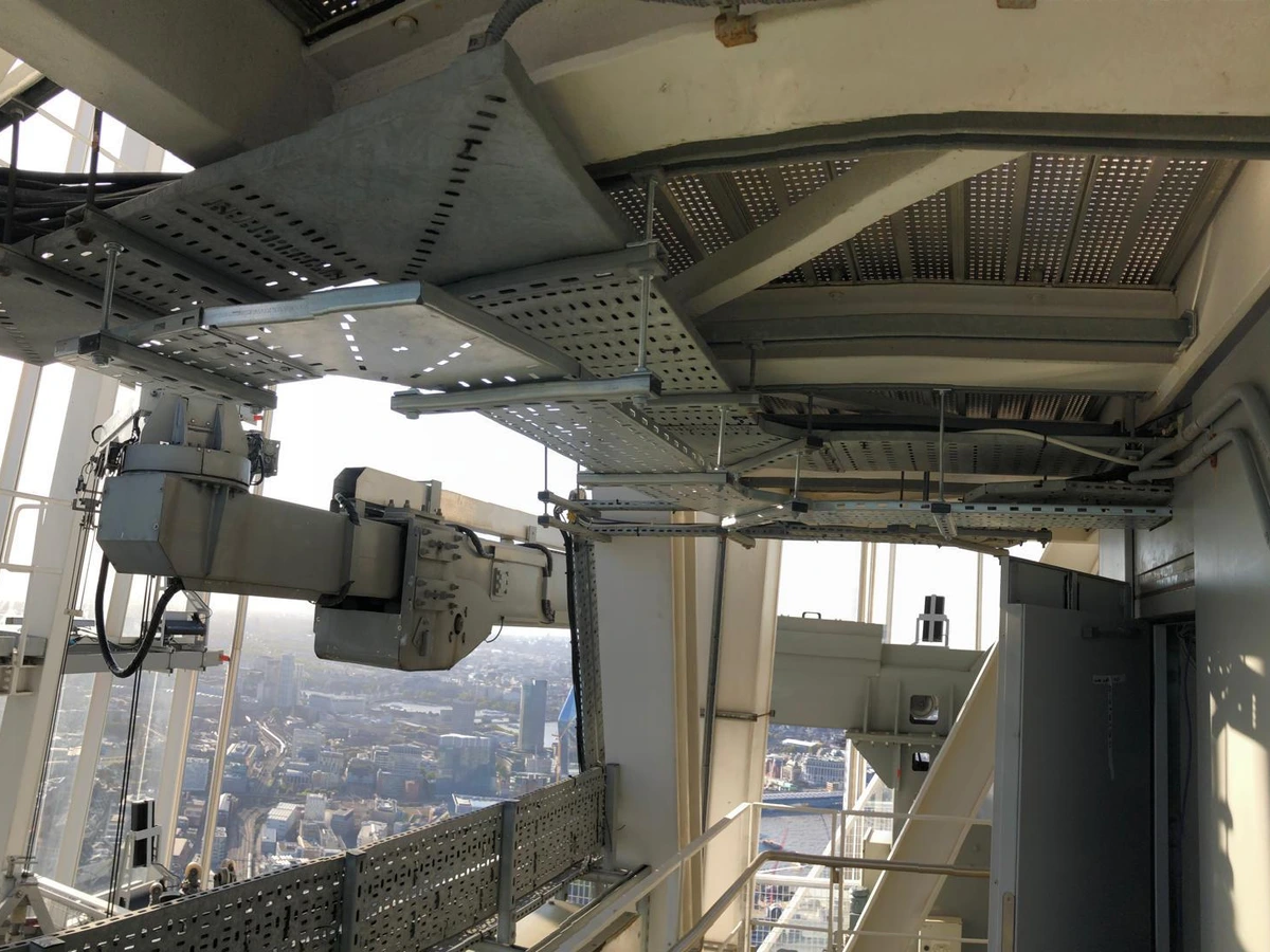 Cable tray and containment fixed under steelwork on the outside of a tall building