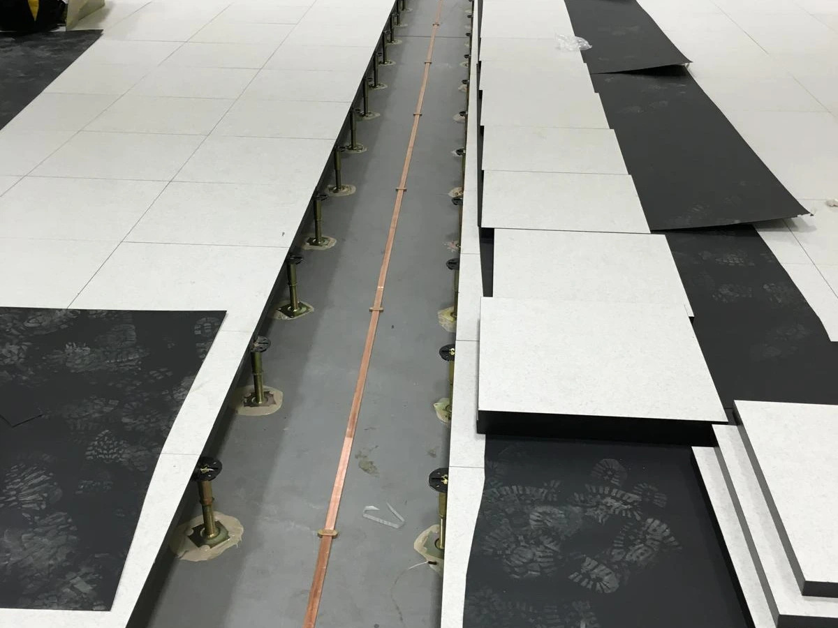 Raised access floor with a cable run laid in the void before tiles are fitted