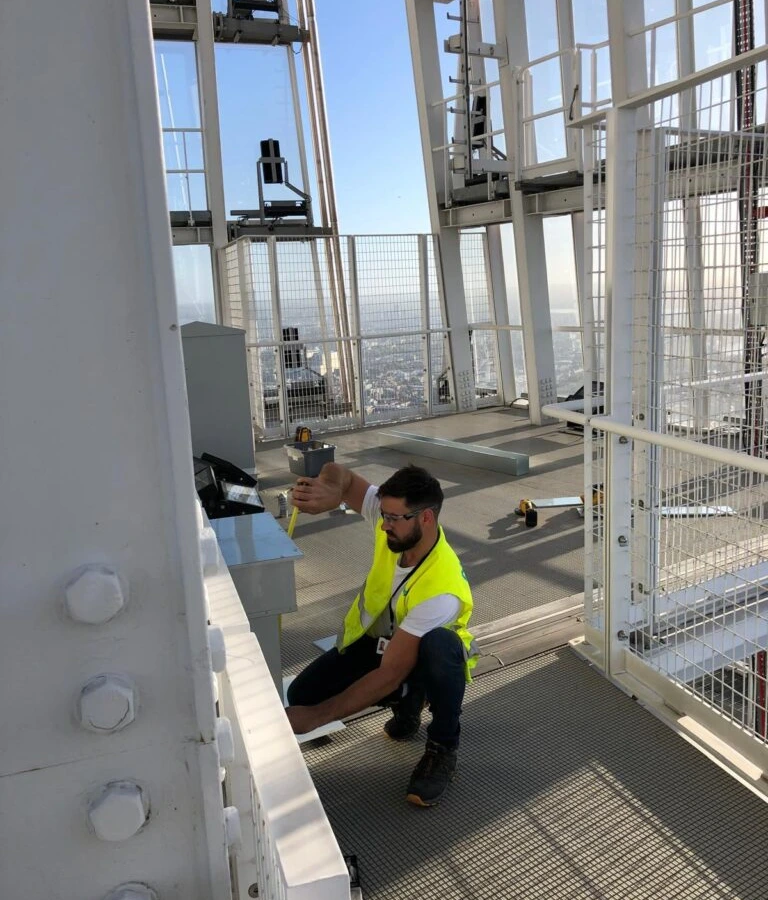 Bello Electrics Ltd staff measuring and working on top of a structure